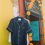 Shirt hanging up on a wall next to a store