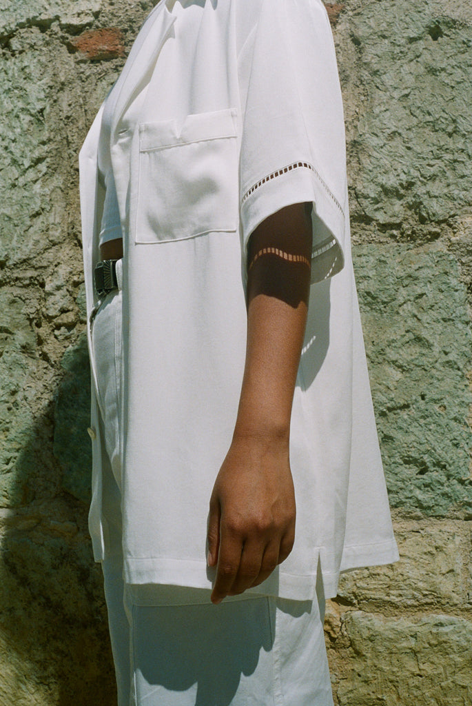 Female model wearing shirt from the right side view