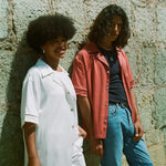 Female model in white cabrisa next to male model in valencia cabrisa