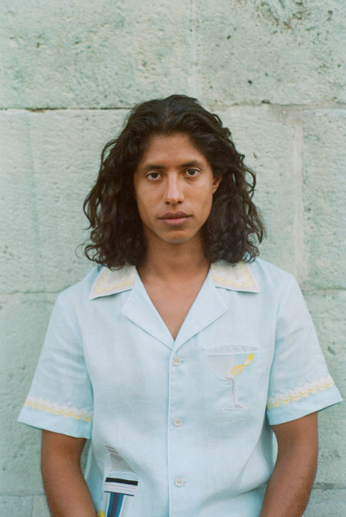 Portrait of man wearing buttoned up linen Tombolo shirt looking straight on