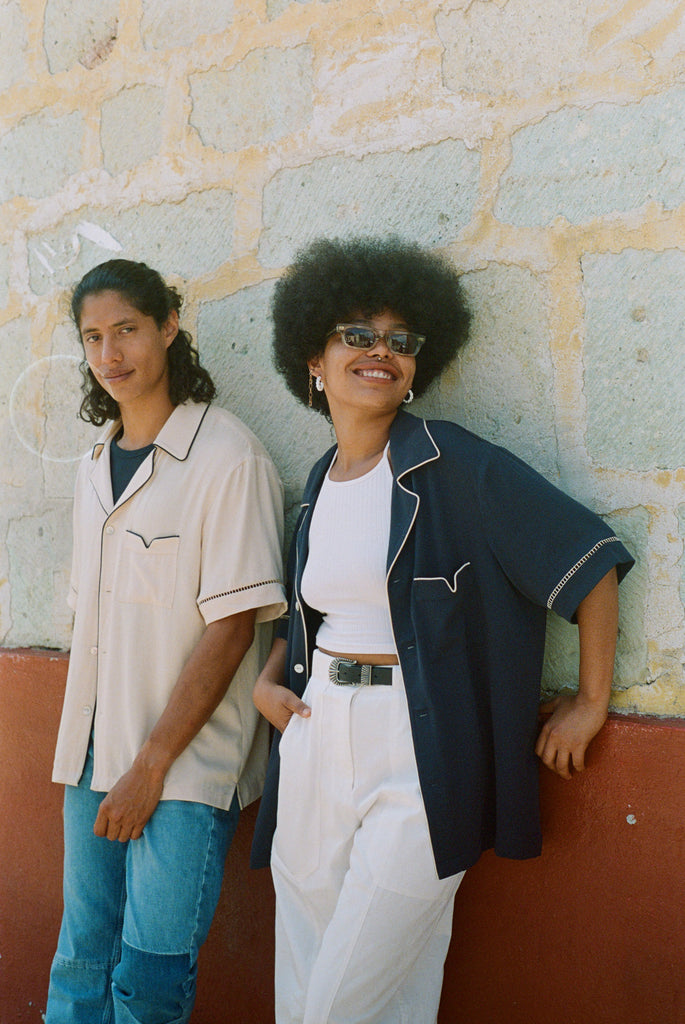 male model wearing the cabrisa shirt in parchment next to a female model wearing the cabrisa shirt in navy