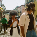 male and female model wearing navy and parchment cabrisas on the street