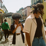 male and female model wearing navy and parchment cabrisas on the street