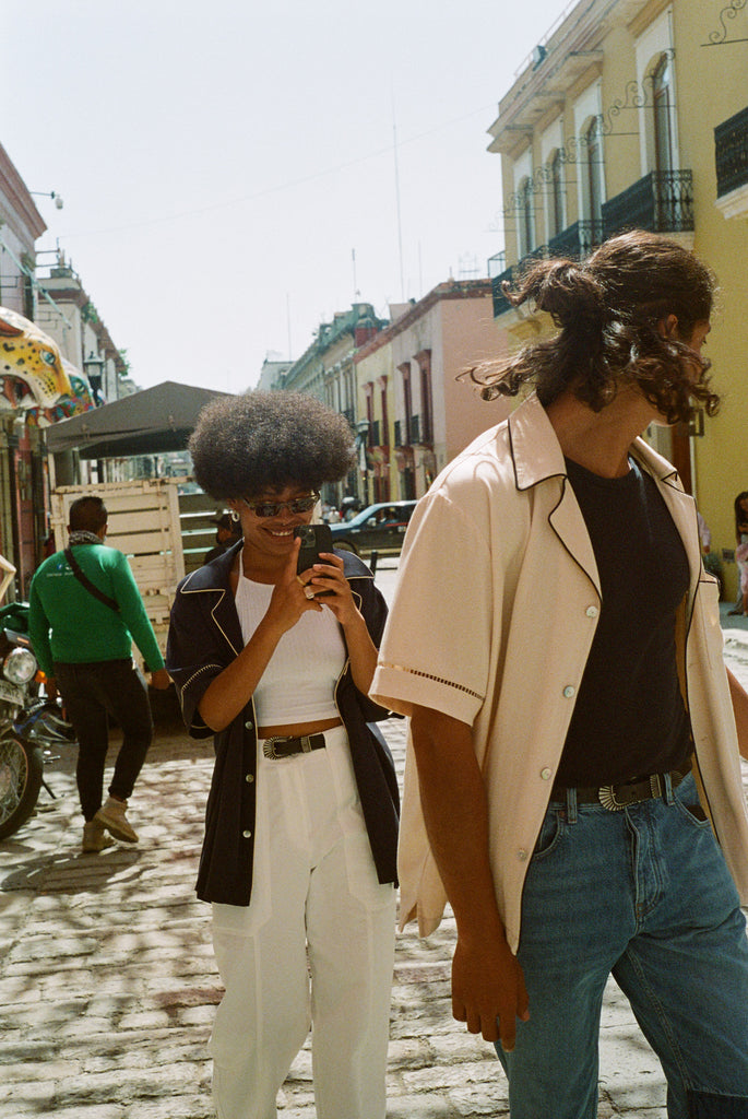 male and female model wearing navy and parchment cabrisas on the street