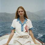 Female model wearing pop over on a boat