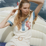Female model in pop over on boat with white shorts