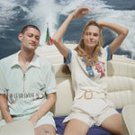 Female model in pop over next to male model in le sirenuse set