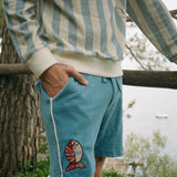 male model in long sleeve le sirenuse tee and pop on shorts with hand in pocket