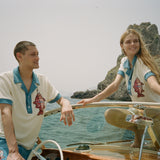 Male and female models on boat both wearing the pop over