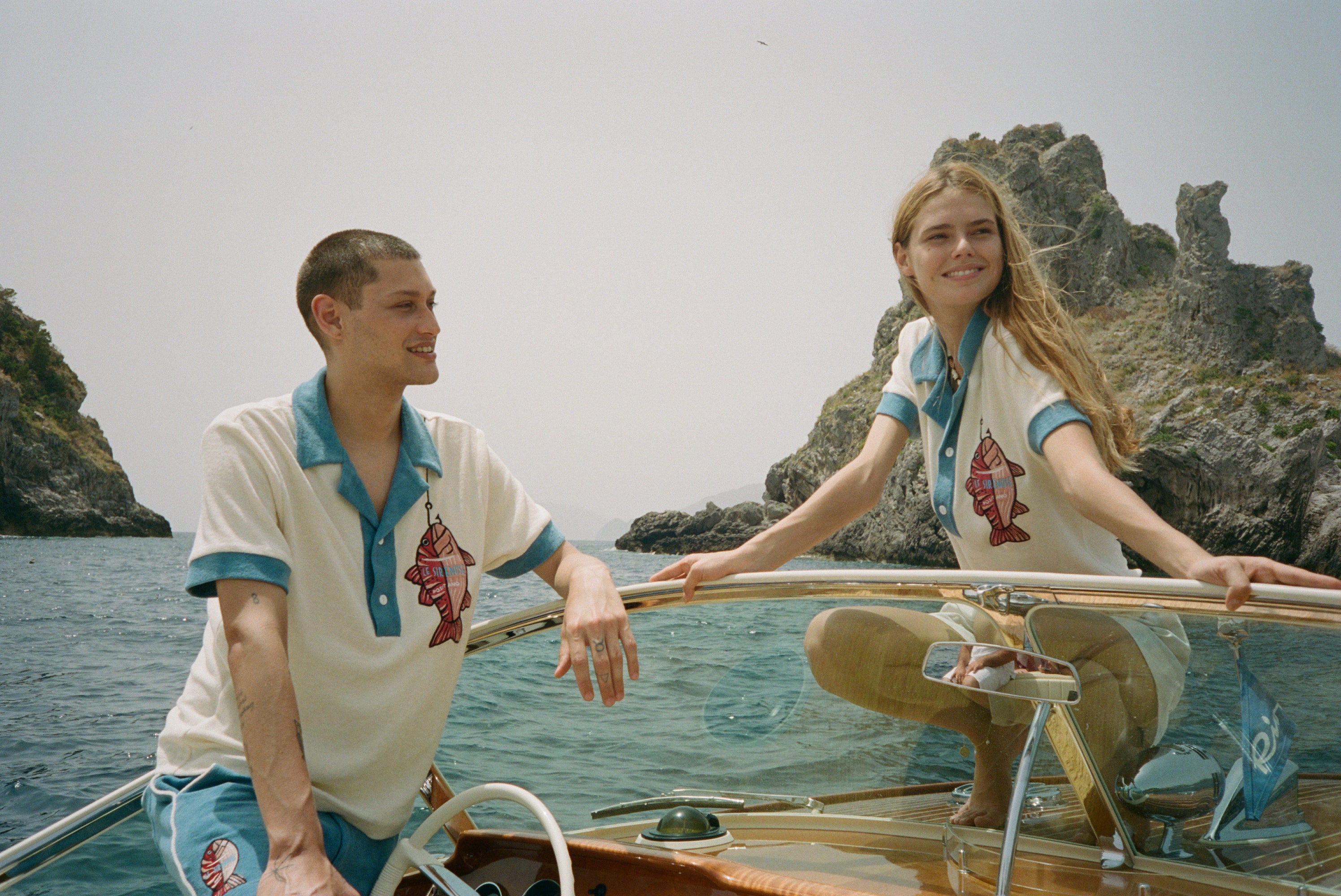Male and female models on boat both wearing the pop over