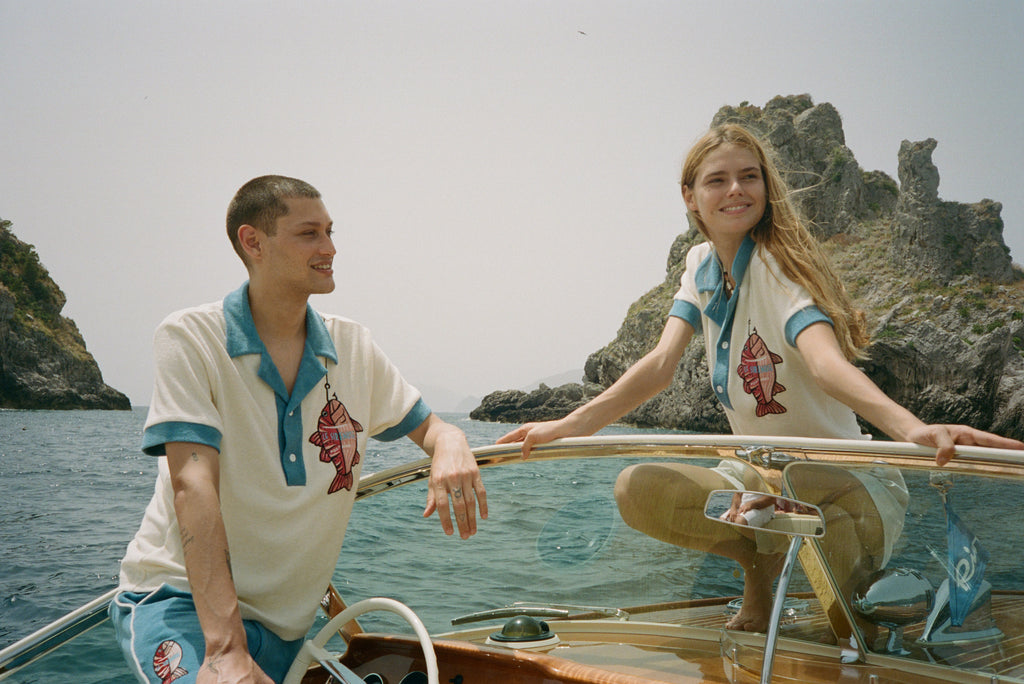 Male and female models on boat both wearing the pop over