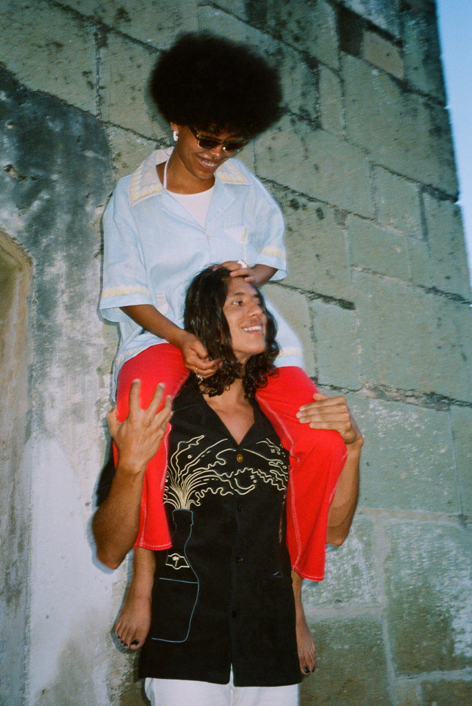 Model wearing Big Brut Cabana carrying a woman on his shoulders