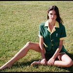 Female model wearing full set sitting in grass
