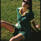Female model wearing full set sitting in grass