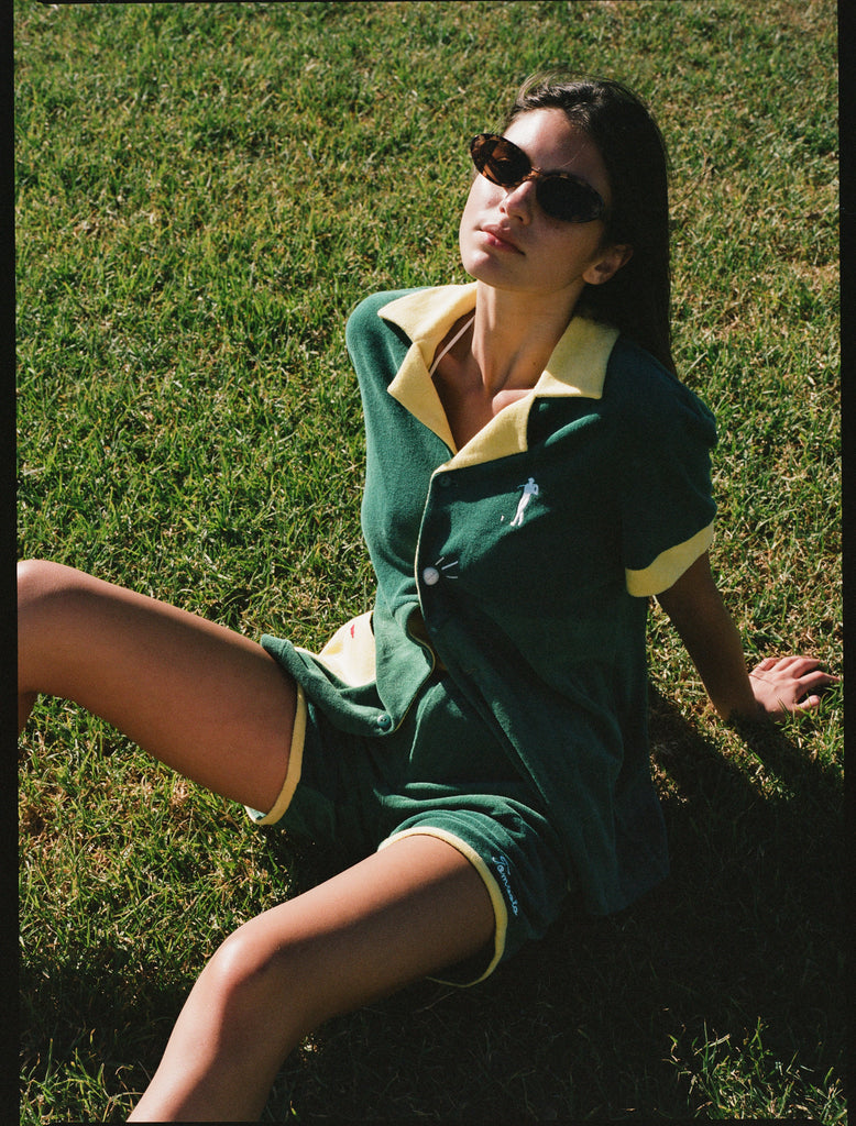 Female model wearing full set sitting in grass