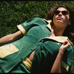 Female model wearing matching set lying down in grass