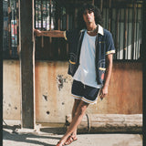 man leans away from pole