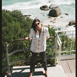 Woman looks up at camera on stairs 