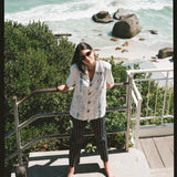 Woman looks up at camera on stairs 
