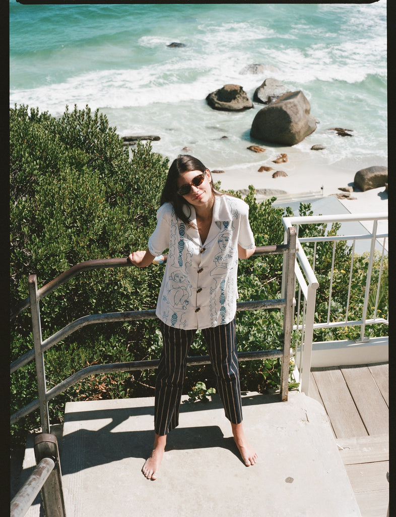 Woman looks up at camera on stairs 
