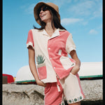 Female model standing wearing the full terry cloth Gusanito set along with a woven sun hat and sunglasses