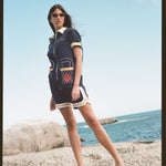 woman stands on rock