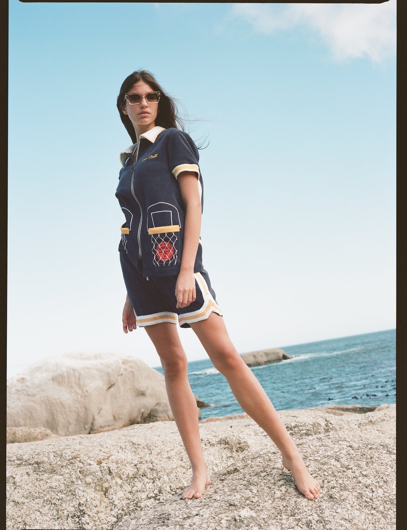 woman stands on rock