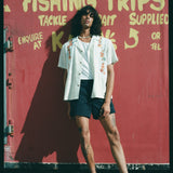 man leans against red wall