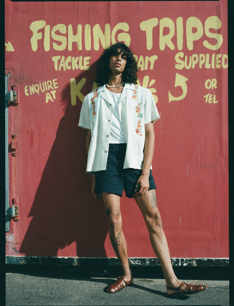 man leans against red wall