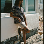 man leans against wall with one foot up