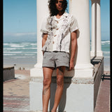 man leans against pillar