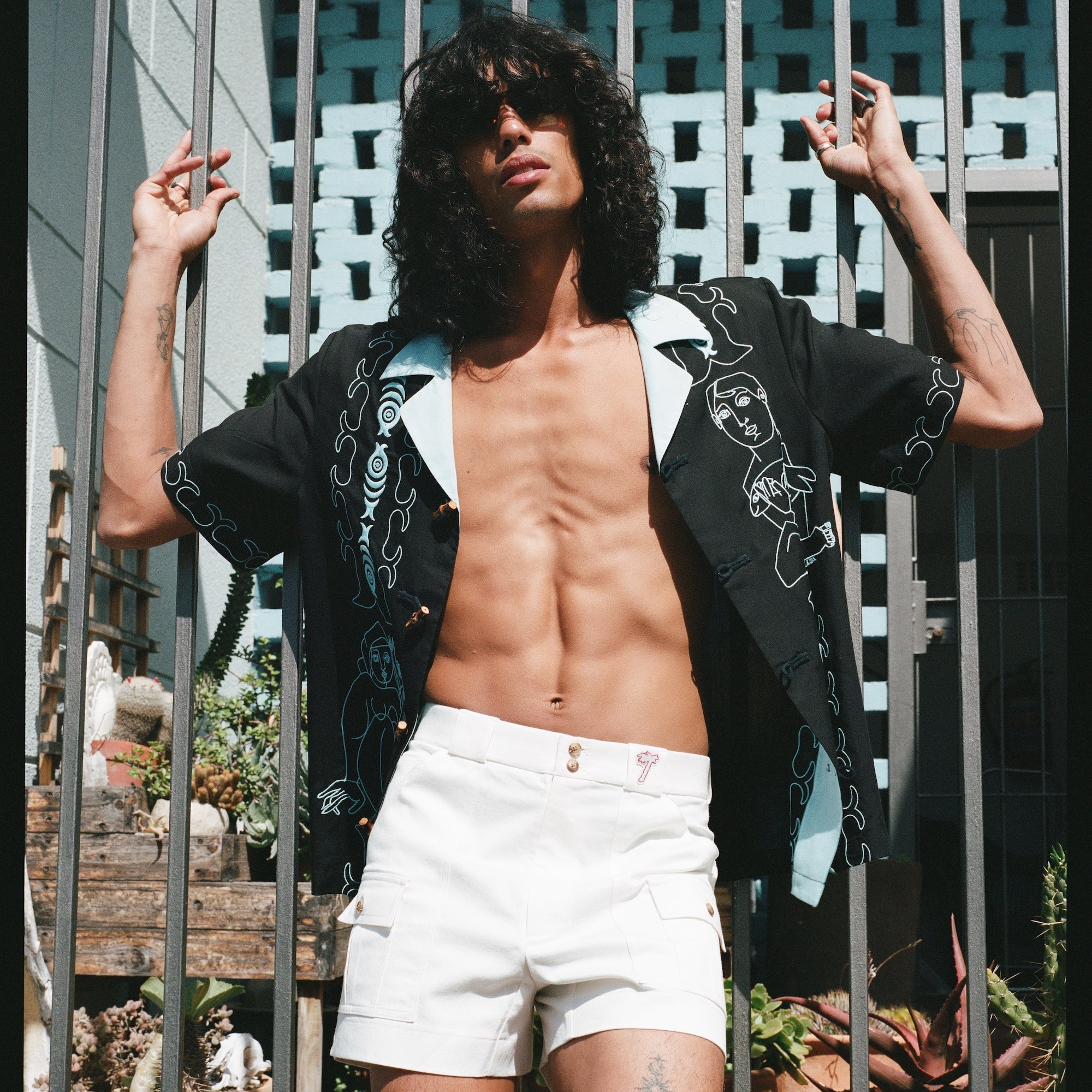 man wears unbuttoned shirt