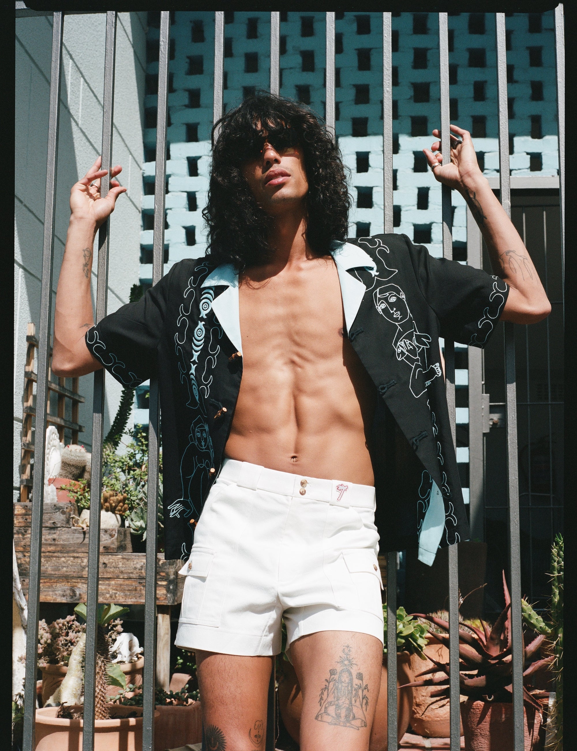 man wears unbuttoned shirt