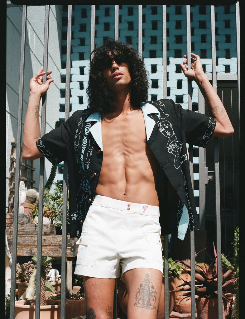 man wears unbuttoned shirt