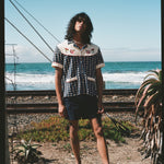 Man staring with ocean in background