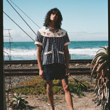Man staring with ocean in background