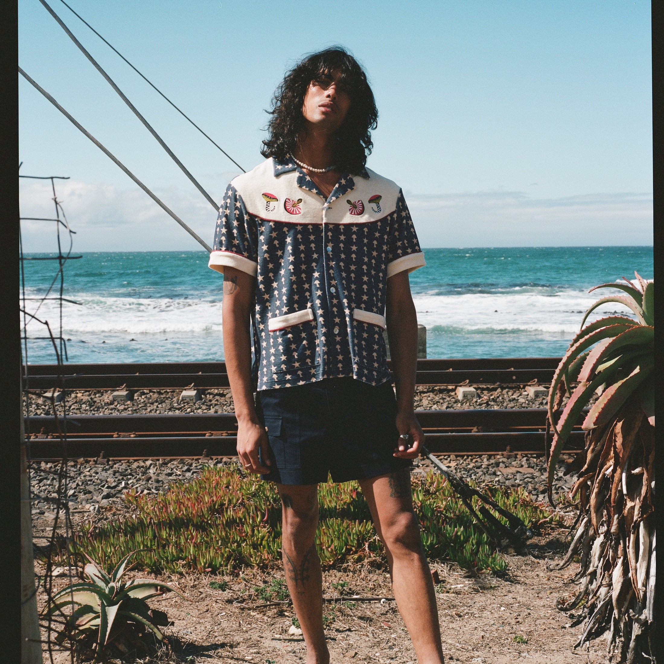 Man staring with ocean in background