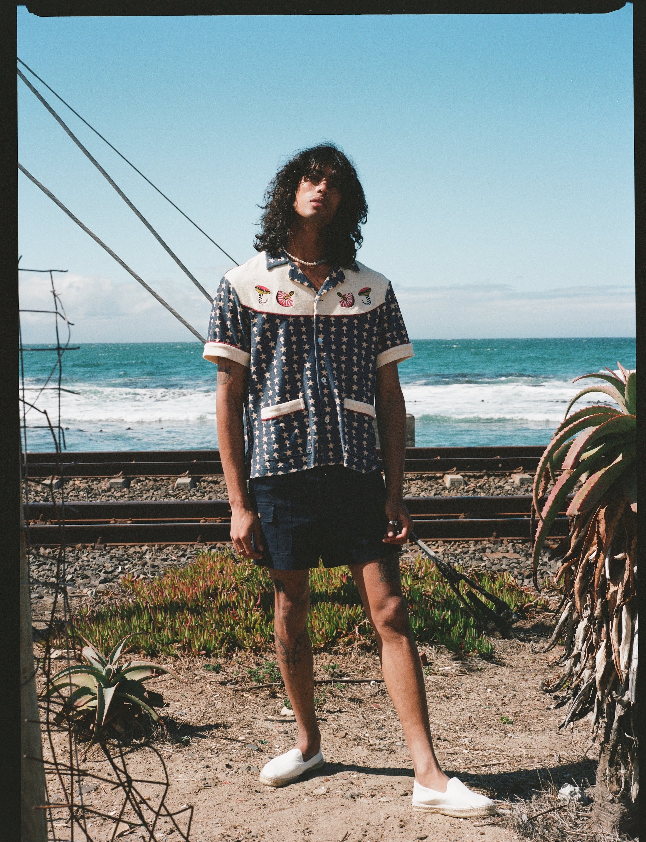 Man staring with ocean in background