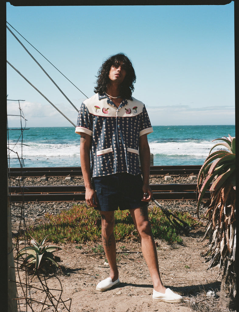 Man staring with ocean in background