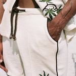 man puts hand in pocket with close up of torso