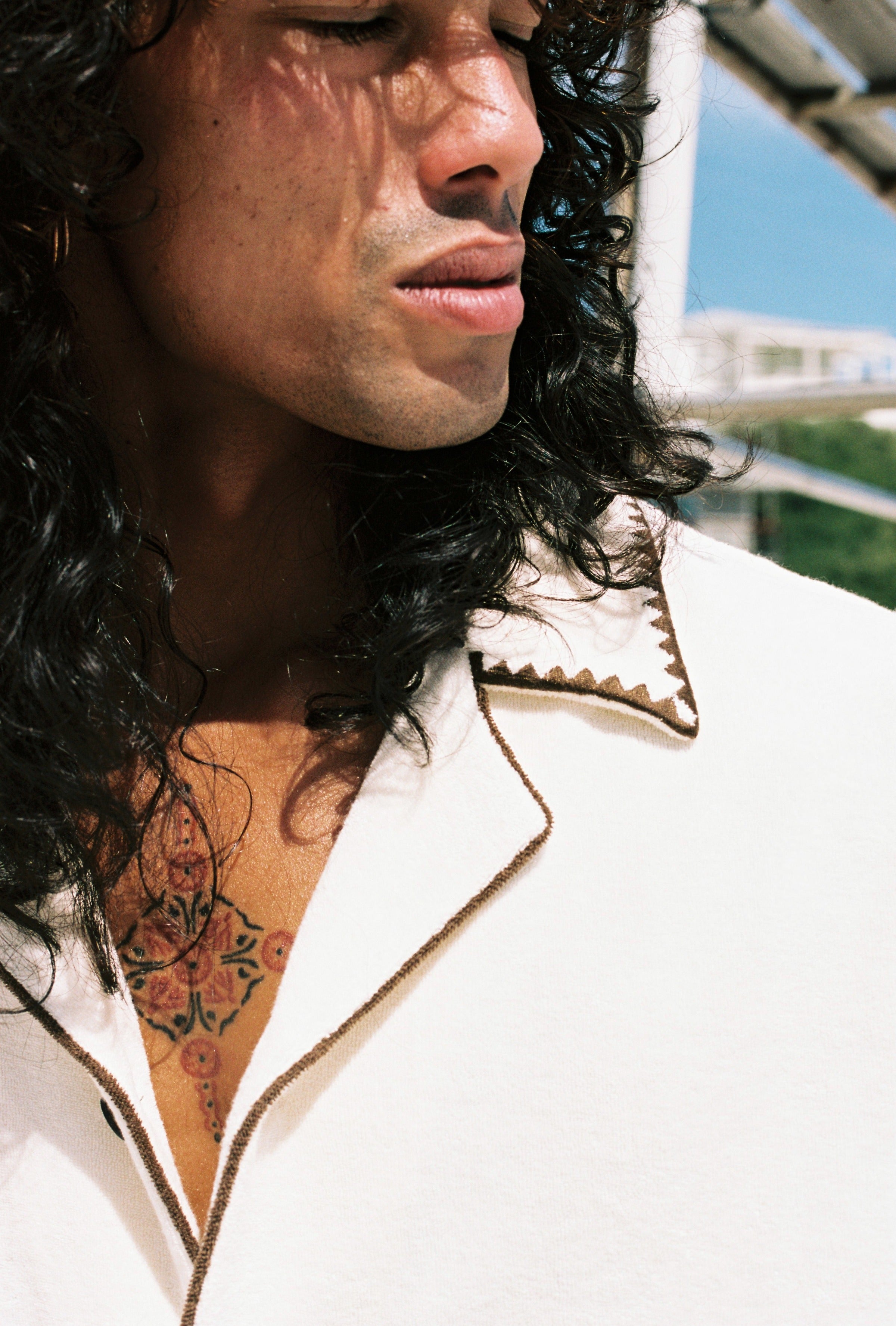 close up of mans face and collar of shirt