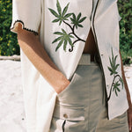 woman wears shirt with one button closed