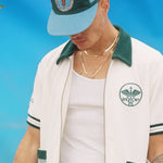 Male model wearing the cap along with the DSNY cabana set