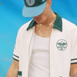Male model wearing the cap along with the DSNY cabana set