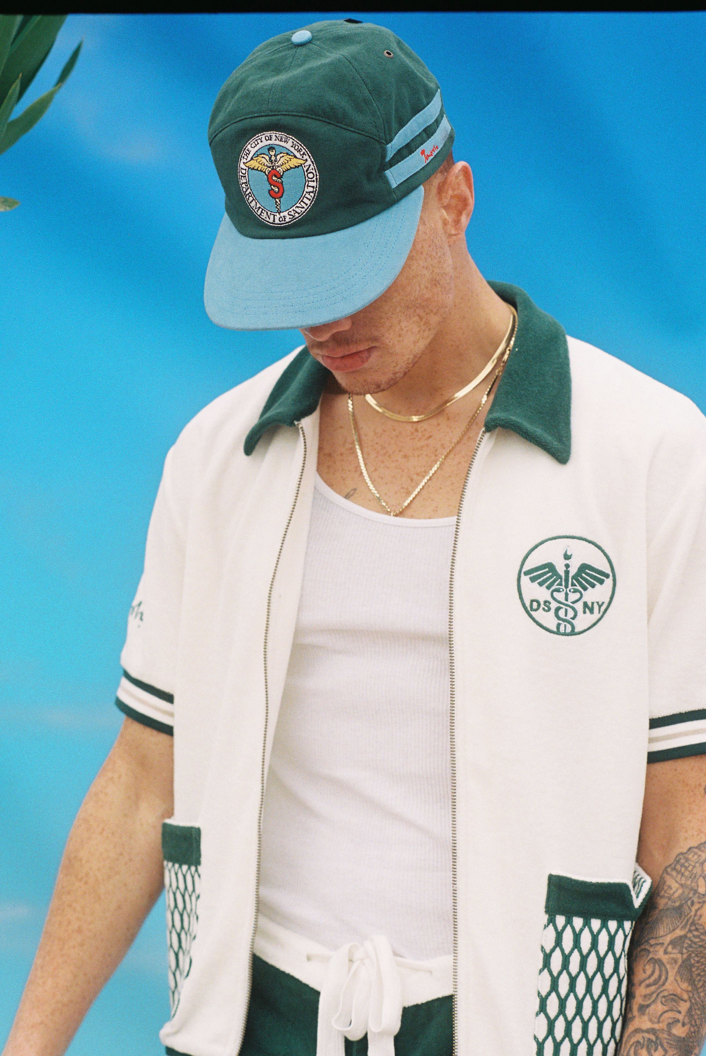 Male model wearing the cap along with the DSNY cabana set