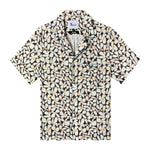 Front view of the sunny disposition hawaiian tee, with a pattern of an abstract field of daisies as well as four brown buttons down the front and blue piping on the collar and front pocket 
