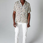 Male model wearing shirt with white pants