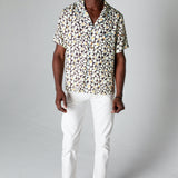 Male model wearing shirt with white pants
