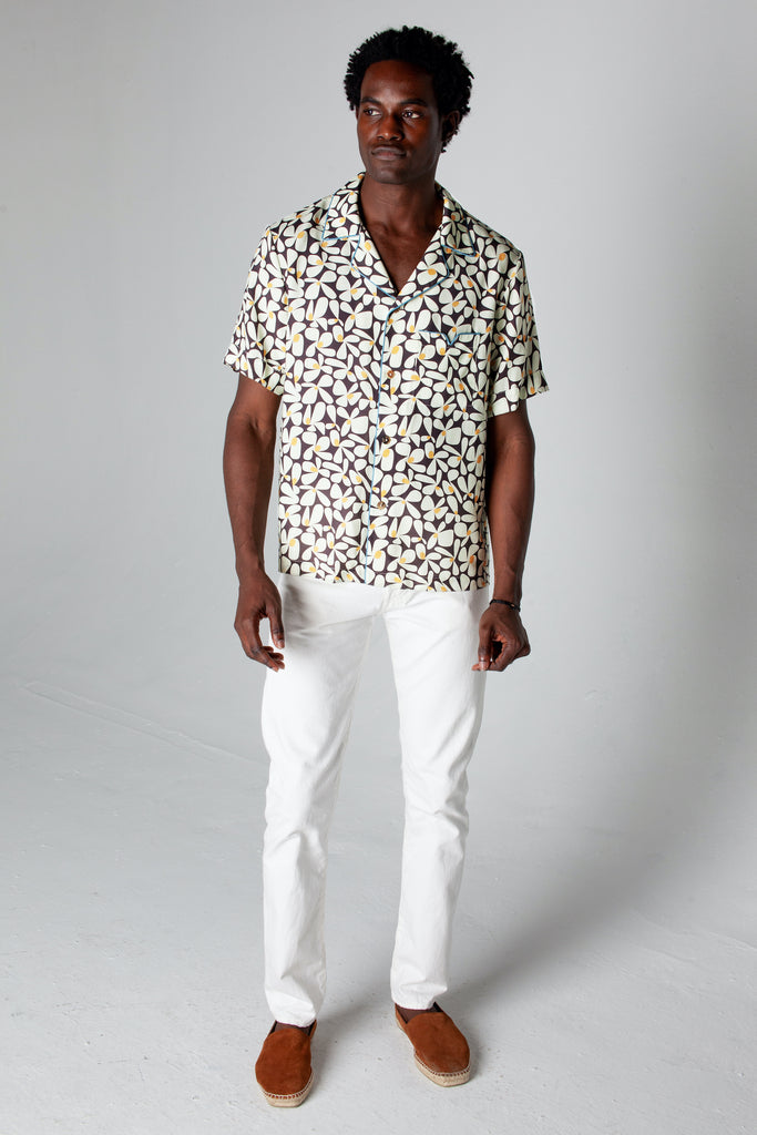 Male model wearing shirt with white pants