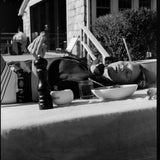 Female model laying on a table outdoors in the vongole crop, photo in black and white